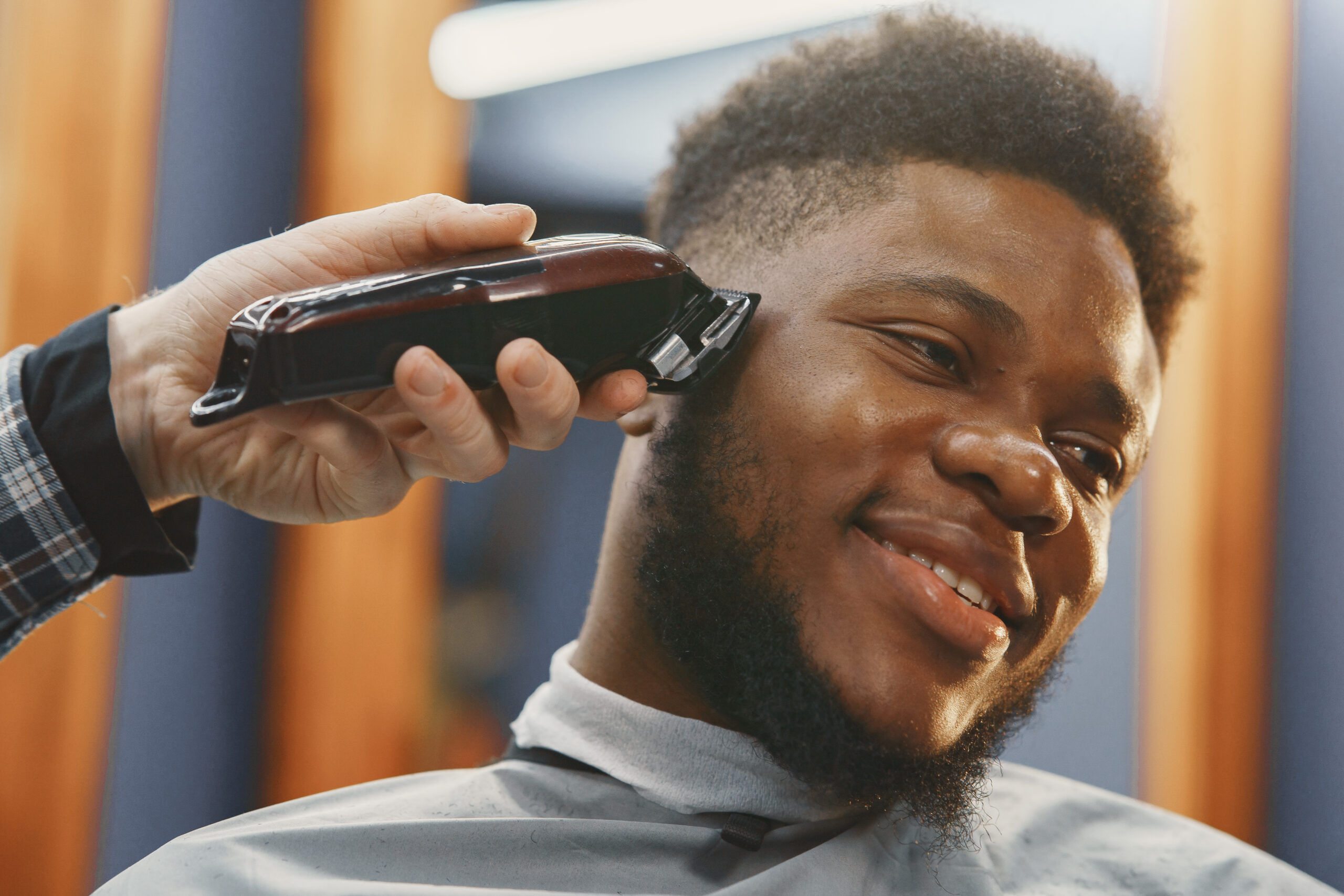 Young African-american man visiting barbershop